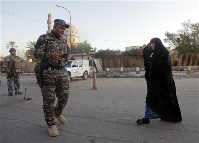 An Iraqi police officer uses a bomb detector to search a woman outside the 14th Ramadan mosque, seen in the background, on the first day of Eid al-Adha in Baghdad, Iraq, Sunday, Nov. 6. Eid al-Adha, or the Feast of the Sacrifice, is celebrated to commemorate the prophet Ibrahim's faith in being willing to sacrifice his son. 